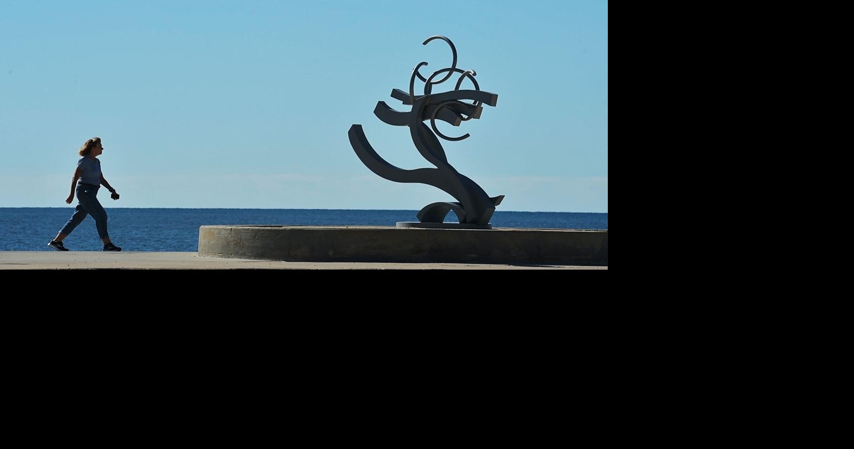 Strolling by a sculpture
