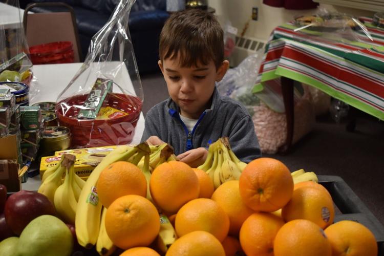 Volunteers with AHEPA 39 assemble food baskets for the elderly