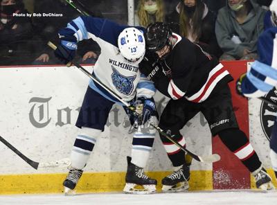 William Allworth (13) battles for the puck against Winchester’s Jack Duncan