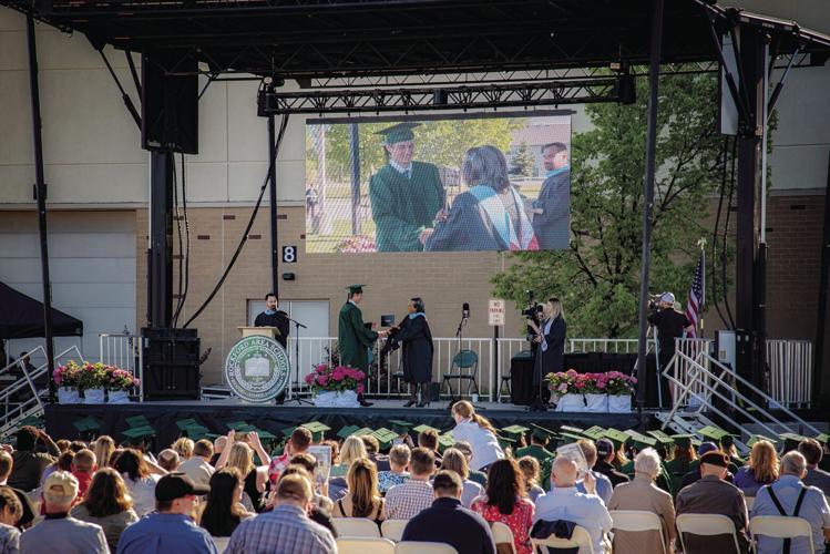Sun shines on outdoor, maskless Rockford High School graduation