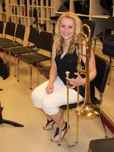 Lillie Herbst packs her trombone for All-State