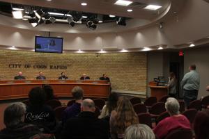 Other Text Alanna Calio, of Fridley,held up a photo of Victor Diaz as she spoke, who had been detained at a Coon Rapids business and died in ICE custody. Alt Text