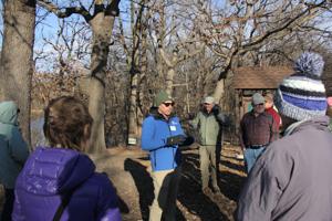 Other Text Fridley Parks and Rec director Mike Maher leads Fridley residents on a tour of Innsbruck on April 8 to discuss invasive plants. Alt Text