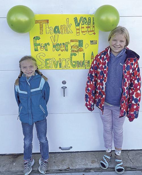 Granddaughters thank grandpa for serving