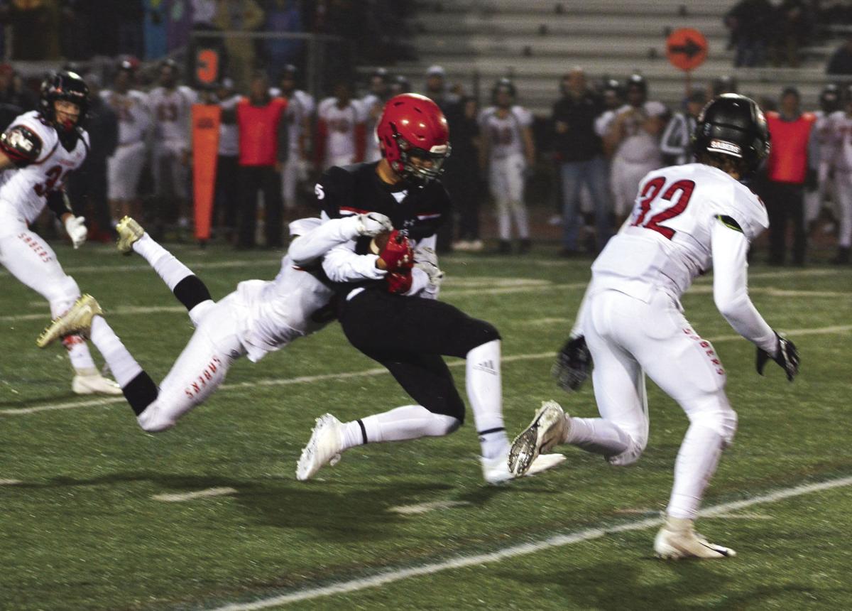 Eden Prairie senior J.D. Cowan, middle, makes a big third-down catch during  the first quarter Friday.