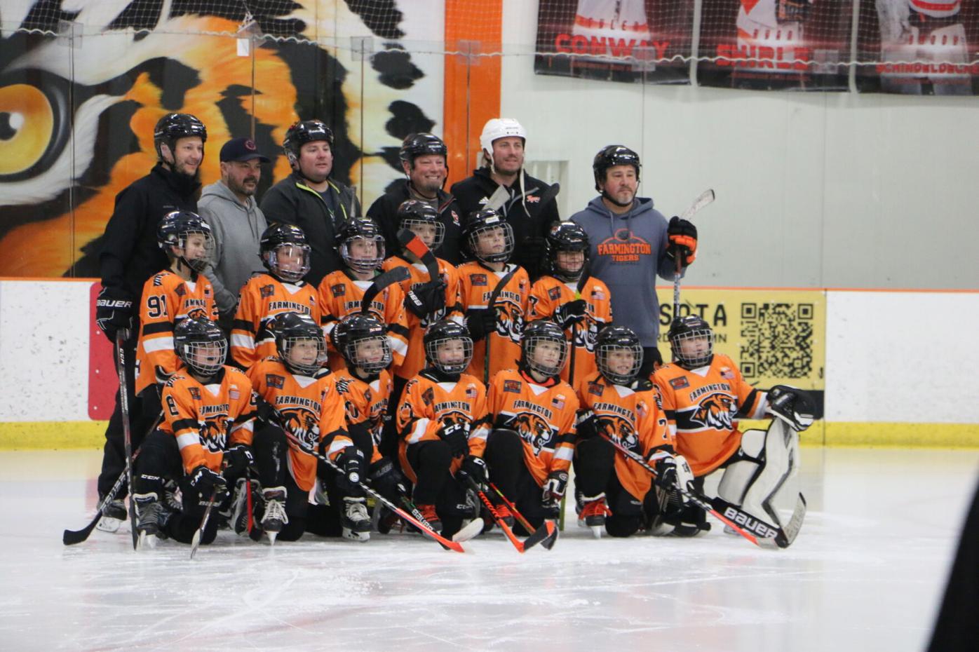 Farmington Ben Dapper poses with hockey teammates