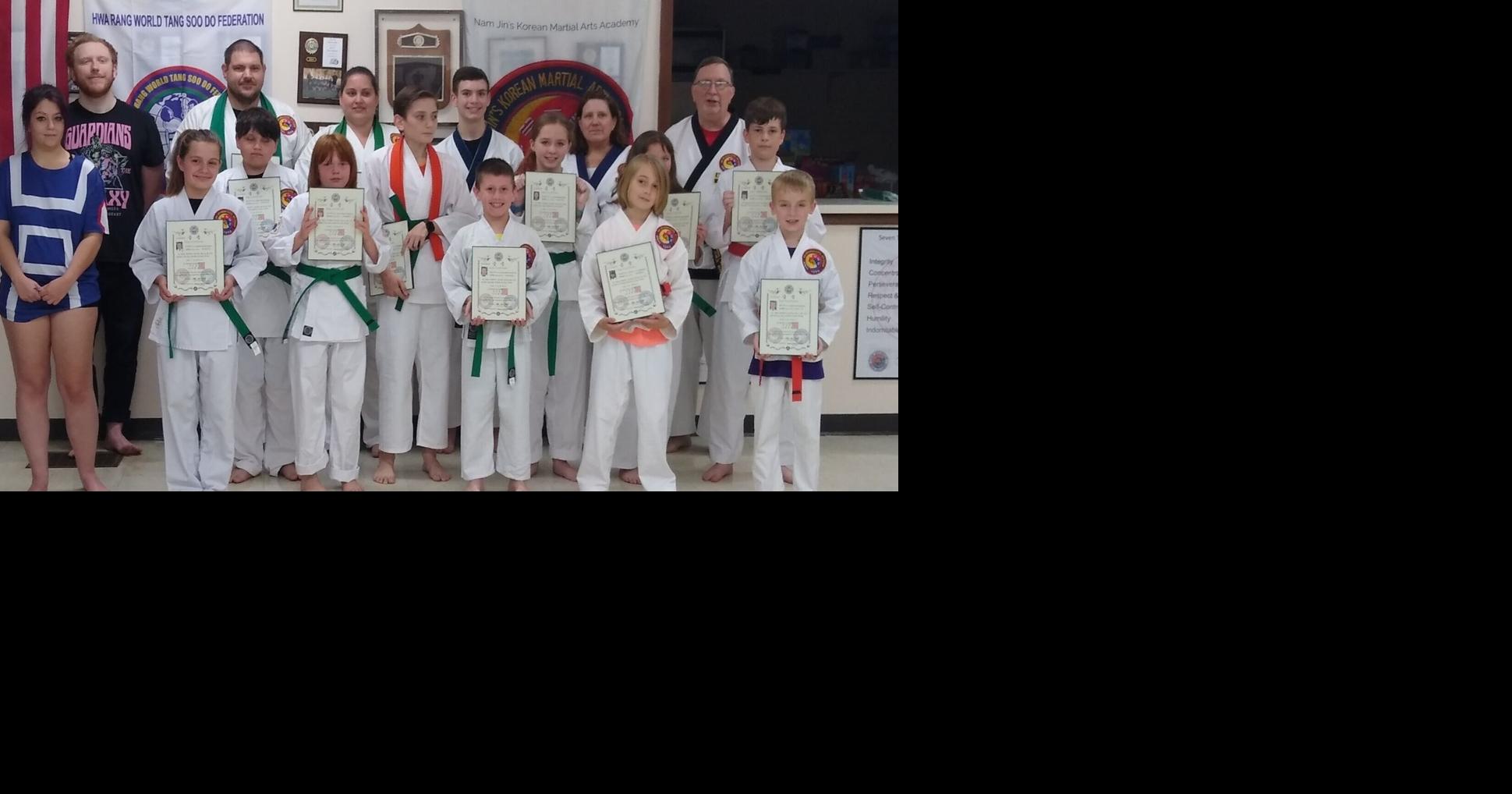 Belt promotion held at martial arts academy People