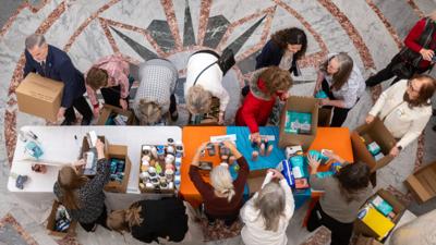Volunteers prepare hygiene kits