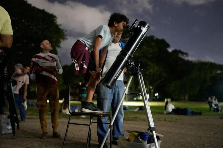 A lunar eclipse lights up skies across the Americas. in photos