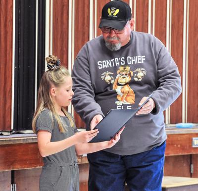 Russell Briney presents Toys for Tots award to Kaydence Cluff
