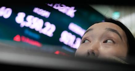 Asian shares trade mixed while the dollar hits a 40-year high against the yen