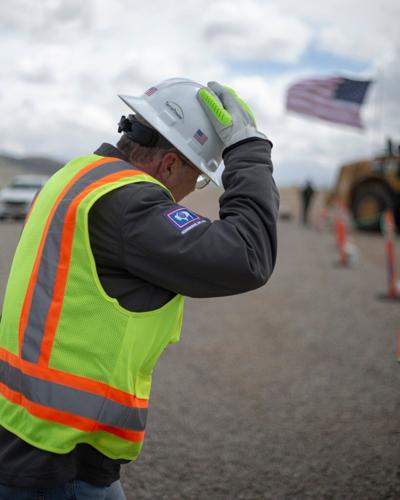 TerraPower Director of Construction Andy Chrusciel holds onto his hat as the wind gusts Wednesday, April 22, 2026, at the site of TerraPower’s Natrium nuclear power plant near Kemmerer.