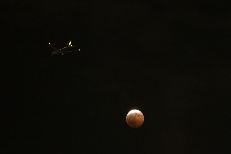 A lunar eclipse lights up skies across the Americas. in photos