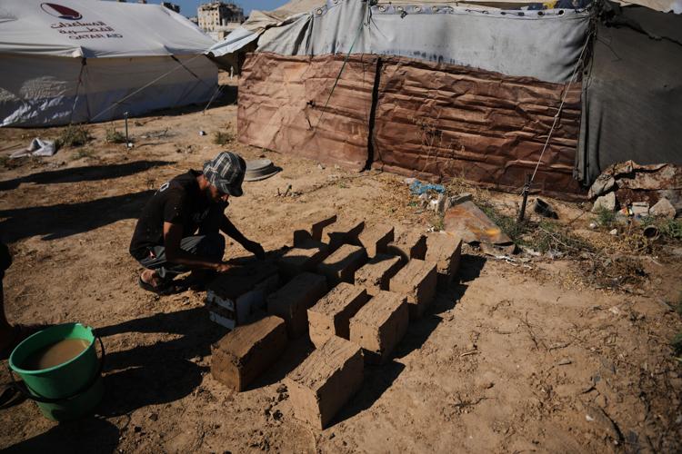 Photos show Palestinians using handmade mud bricks, wood and plastic to rebuild amid Gaza’s rubble