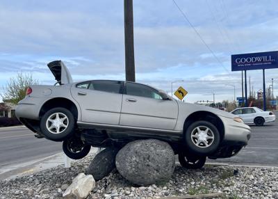 Car stuck on boulder