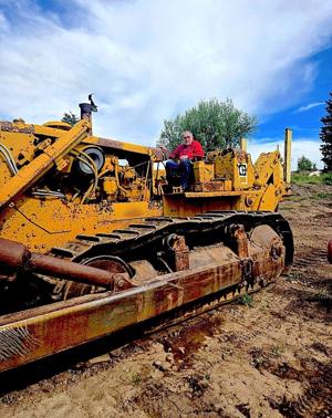 General Excavation Foreman Jay Calderwood takes a ride on Caterpillar D9 used during flood