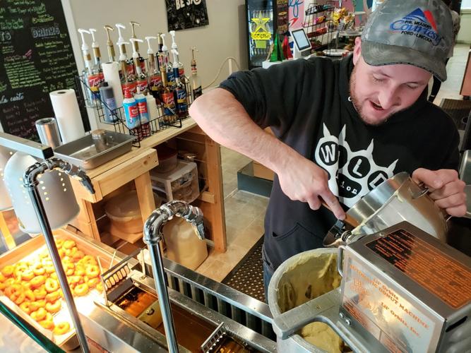 Donut Bros employee dropping batter