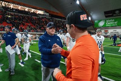 Dan Hawkins shaking hands with Cody Hawkins
