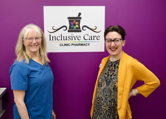 Inclusive Care Clinic Pharmacy founders inside their Chubbuck pharmacy beneath the store sign