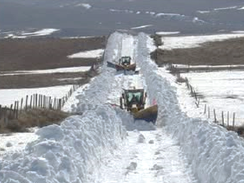 snow plows on county road