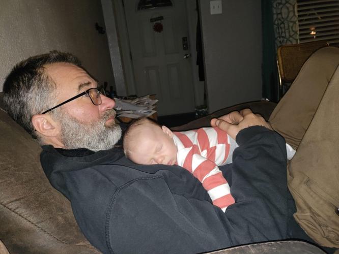 Chris Lippie holding son