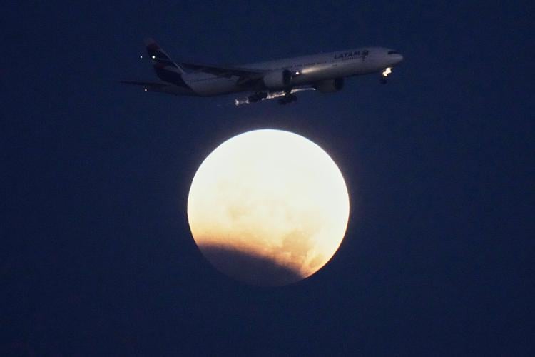 A lunar eclipse lights up skies across the Americas and Europe, in photos