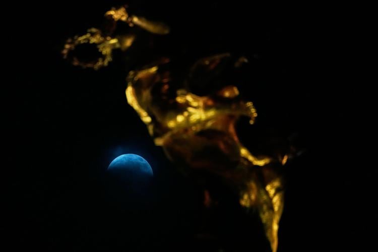 A lunar eclipse lights up skies across the Americas. in photos