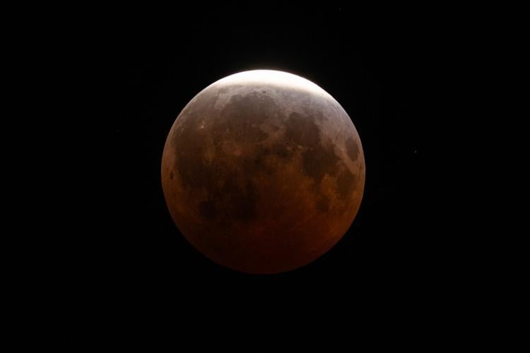 A lunar eclipse lights up skies across the Americas. in photos