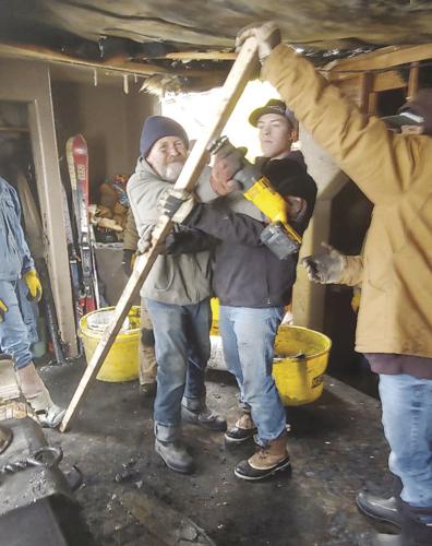 Neighbors help repair home after fire