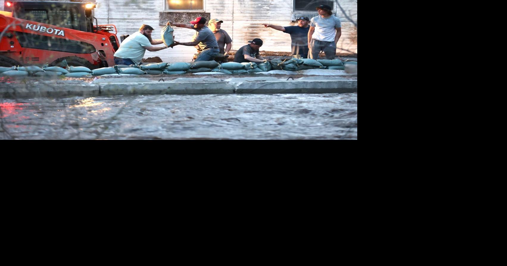 TOWN SAVED About 100 volunteers work late into night to divert