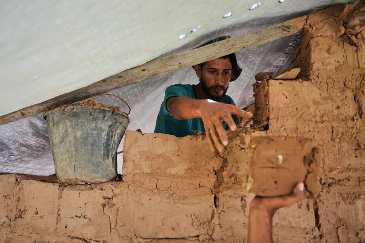Photos show Palestinians using handmade mud bricks, wood and plastic to rebuild amid Gaza’s rubble