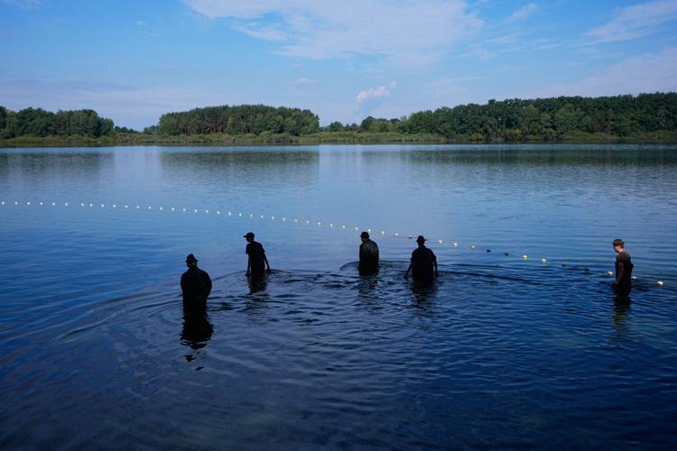 Photos show European fishers on the brink as summer drought parches rivers, lakes and farms