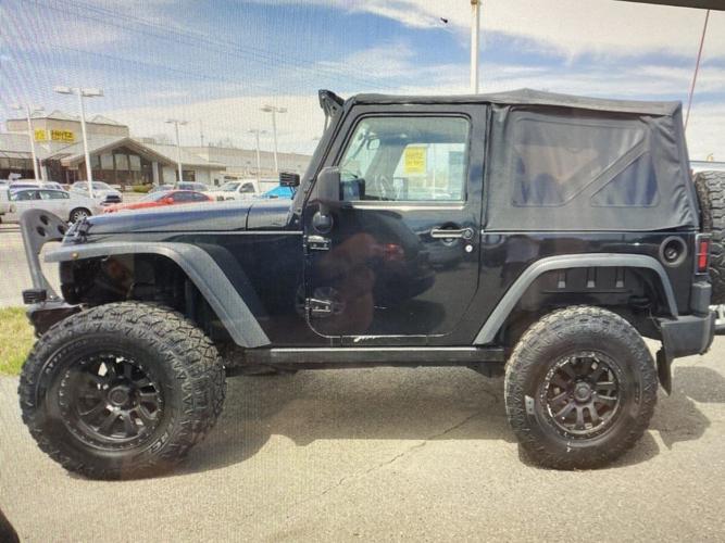 stolen black 2014 Jeep Wrangler Sport edition