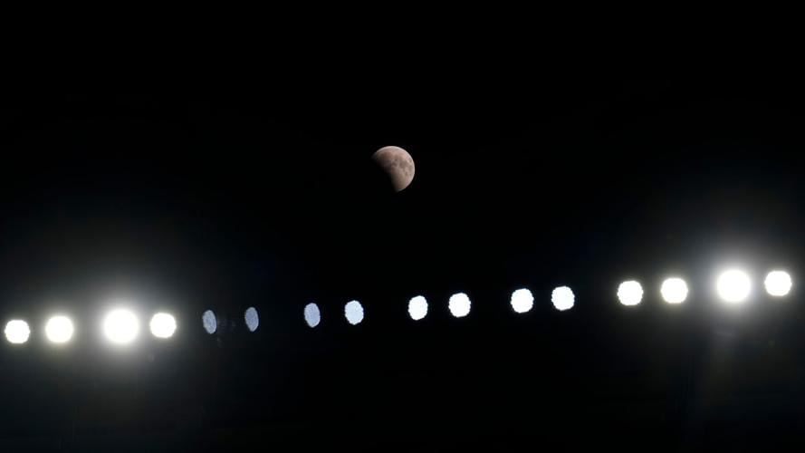 A lunar eclipse lights up skies across the Americas. in photos