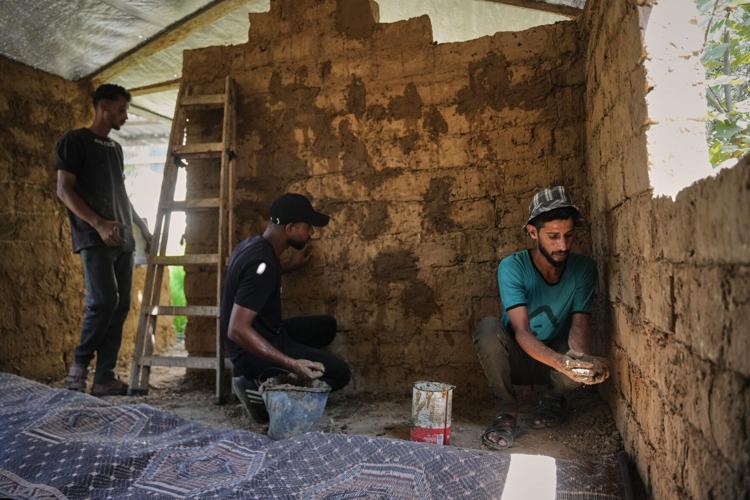 Photos show Palestinians using handmade mud bricks, wood and plastic to rebuild amid Gaza’s rubble