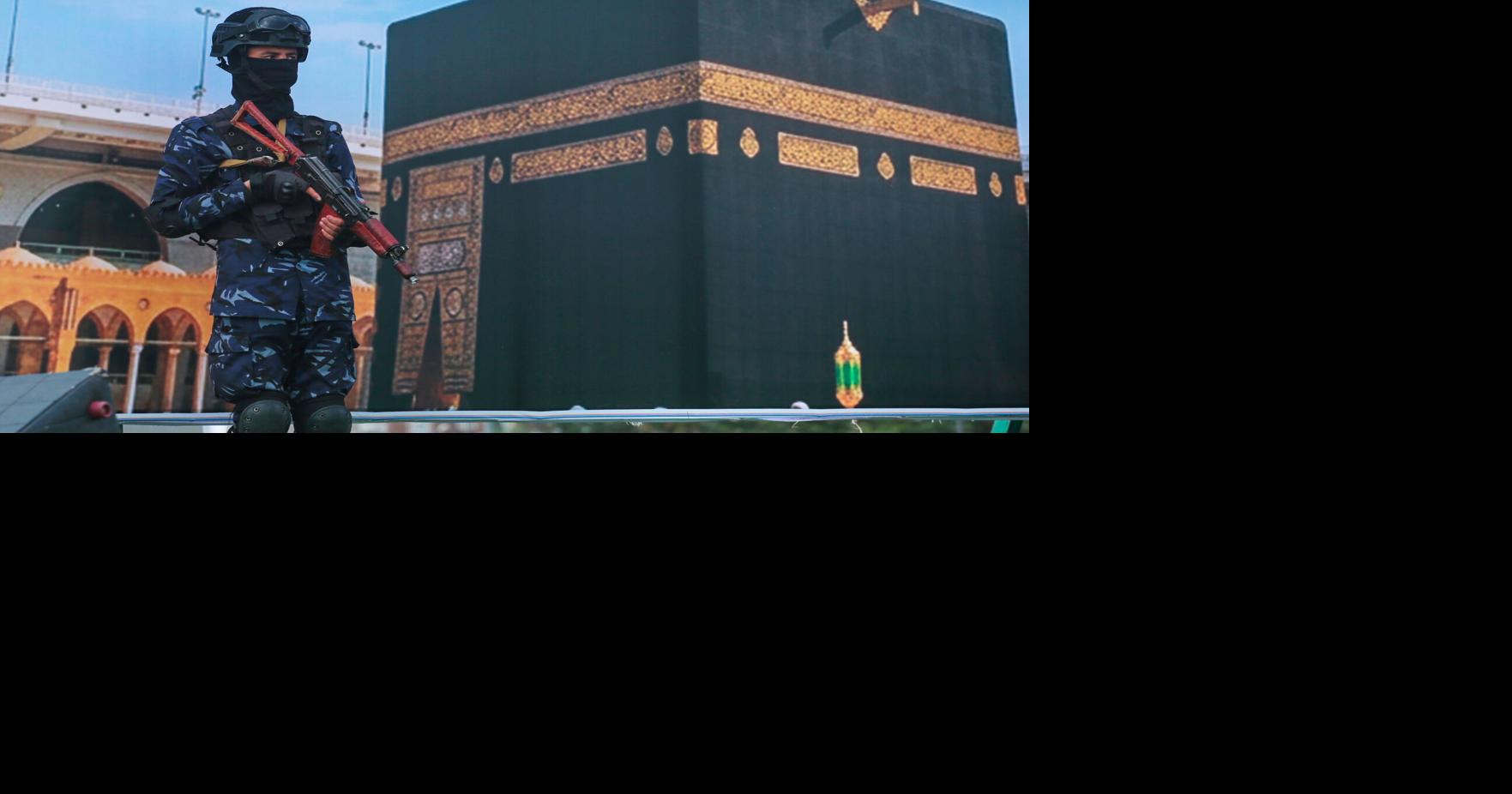 Houthi rebels rally in Sanaa to protest Saudi Arabia's accusation that they targeted the Kaaba; soldier stands before giant Kaaba banner