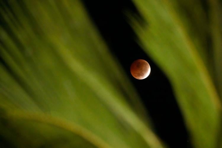 A lunar eclipse lights up skies across the Americas and Europe, in photos