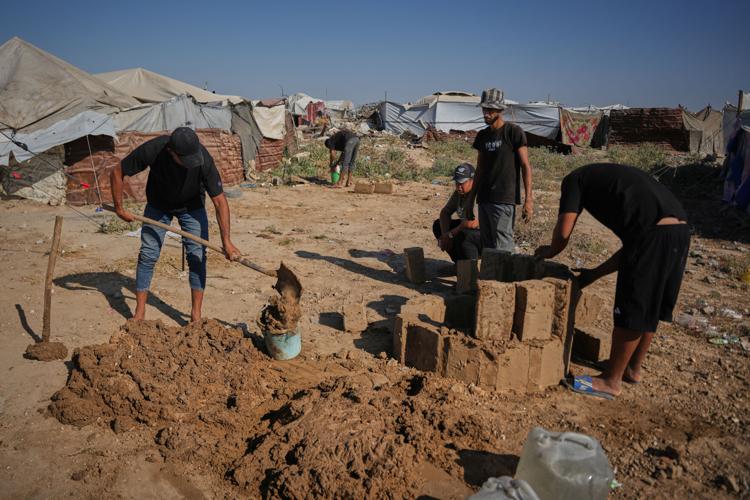 Photos show Palestinians using handmade mud bricks, wood and plastic to rebuild amid Gaza’s rubble