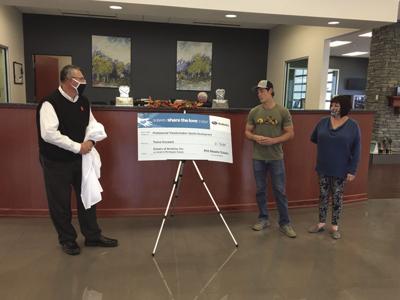 Phil Meador Subaru Gives Check to Russell Davies