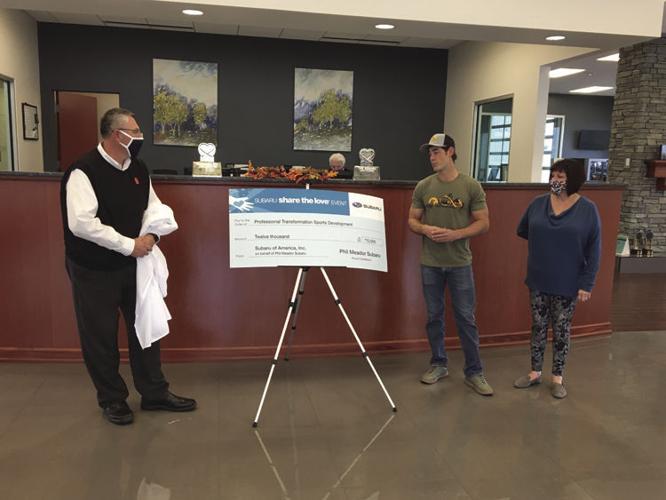 Phil Meador Subaru Gives Check to Russell Davies