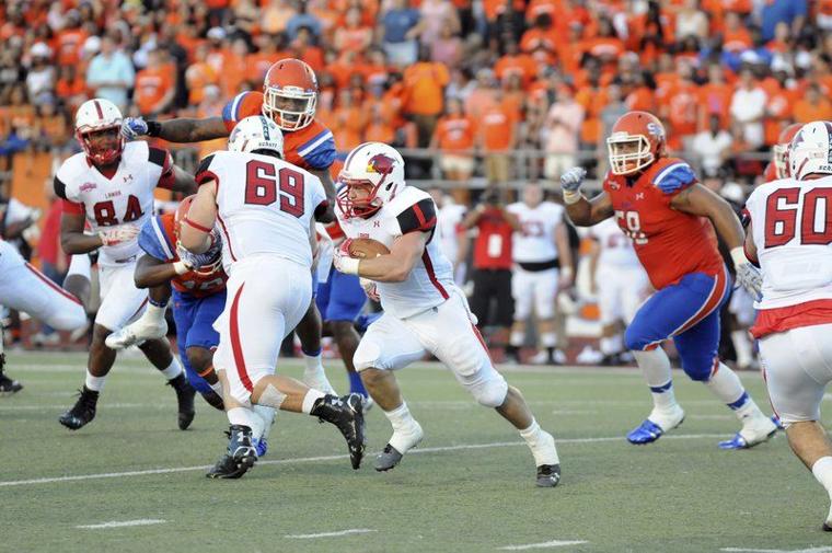 Cardinals running back Kade Harrington finds a hole in the Bearkats line during the first quarter at Bowers Stadium on Saturday night. Harrington gashed the Bearkats for 230 yards on the ground and 83 in the air picking up three touchdowns to beat Sam Houston 49-46 in both teams conference opener. (Joshua Yates/The Huntsville Item)