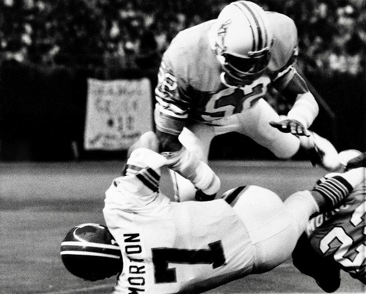 Houston Oiler quarterback Dan Pastorini (7) is sacked from the