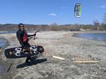 The local kiteboarder Wing Eng surfs in the water at Myers Park in Lansing.