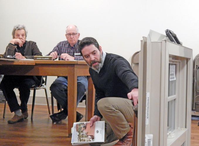Steven Hugo, principal architect at HOLT Architects, shows the Trumansburg Village Planning Board a sample of the windows being considered for the residential units at 46 South Street at the board’s meeting March 28.