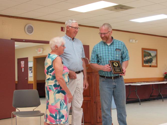 Bob and Nancy Riggs being presented with a plaque of the 2022 Candor Citizens of the Year by the Candor Community Services Corp. President Melvin Foster.