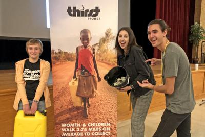 S-VE student Phoebe Delmage-Brodie holding a five-gallon jerry can for hauling water with Mikayla Martinez and Paul Rivas of Thirst Project.