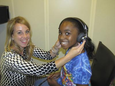 Audiologist Monica Brace with a young client
