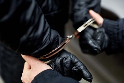 Hands,Handcuffed,Behind,The,Back,Of,Police,At,Arrest