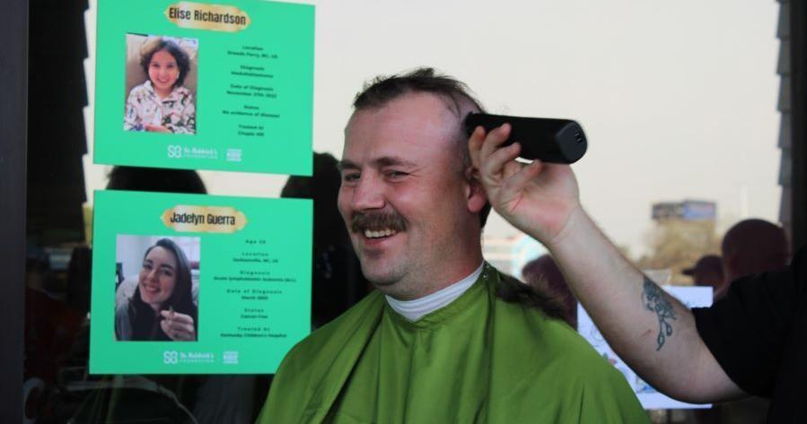 Volunteers shave heads to support child cancer research
