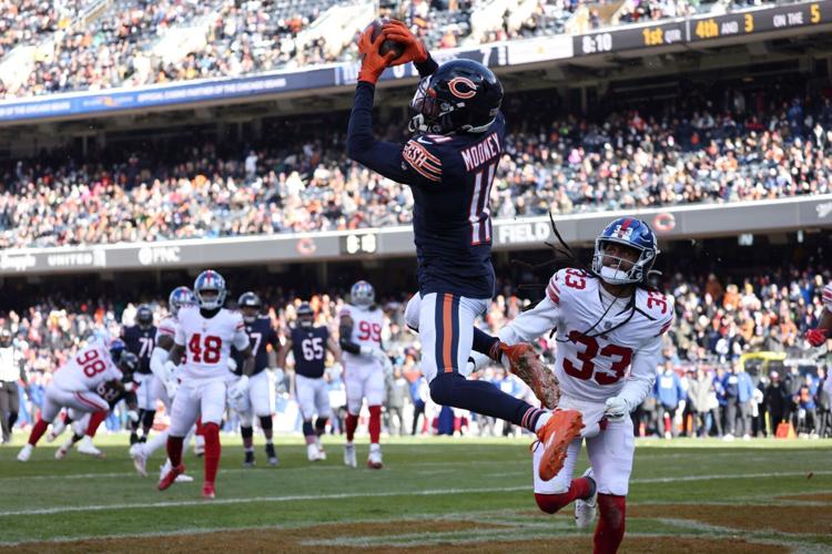 Chicago Bears wide receiver Darnell Mooney (11) makes a touchdown reception against New York Giants cornerback Aaron Robinson (33) in the first quarter, Jan. 2, 2022, at Soldier Field.